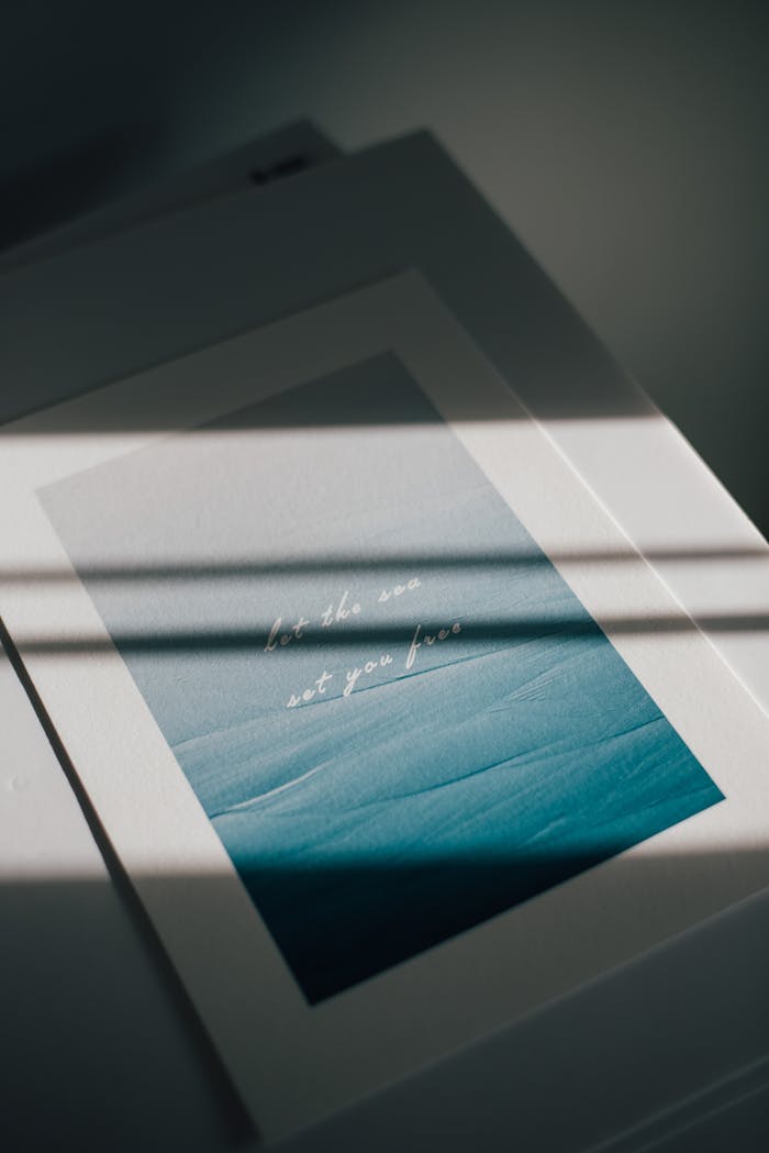 Decorative art piece with inspirational text illuminated by sunlight and shadows.